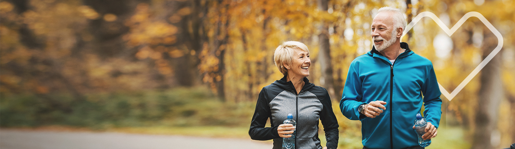 Senior couple jogging in the woods